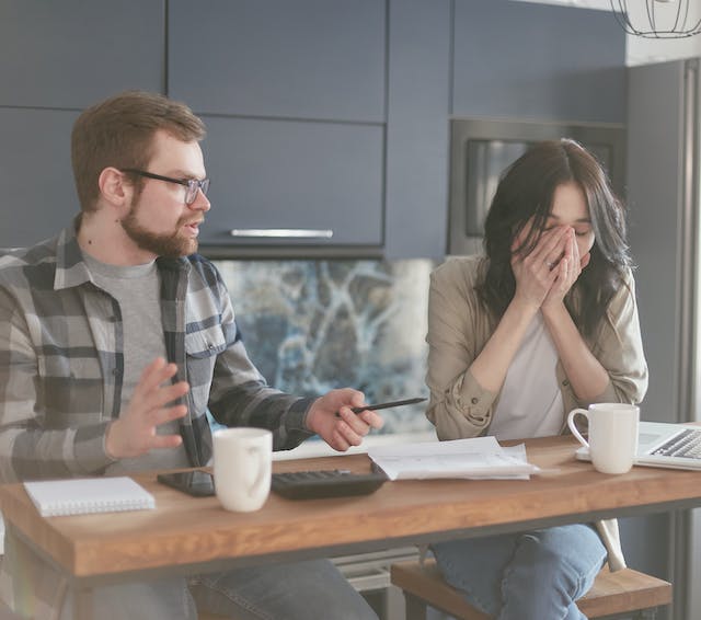 stressed couple looking at documents