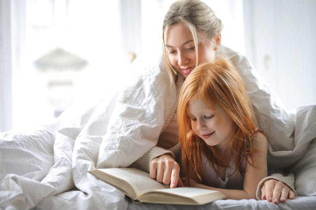 mother and child reading in bed